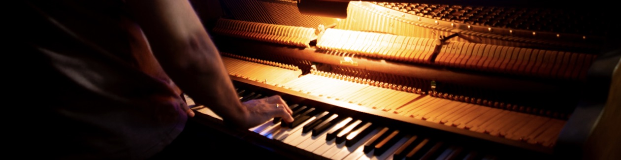 Composer Antonio Romero playing piano at his studio